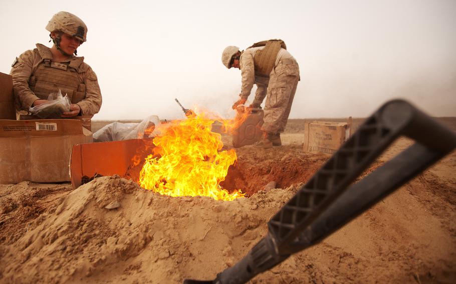 Marines burning trash in Afghanistan. Photo by Alfred V. Lopez